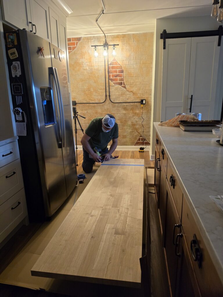 Carpenter in Chicago measuring and cutting a butcher block countertop slab