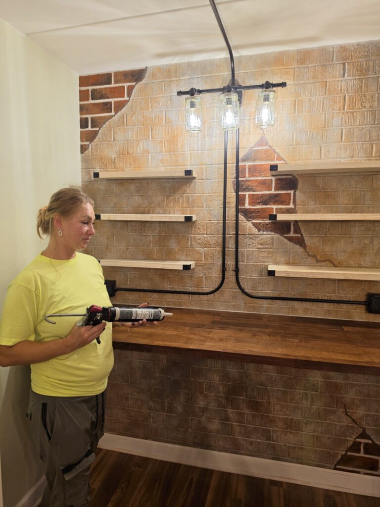 Carpenter in Chicago finishing floating shelves and a stained butcher block countertop