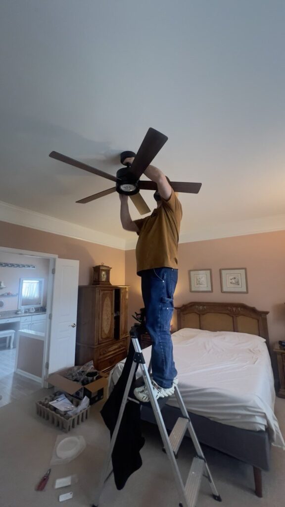 Ceiling fan installation Chicago — installing a ceiling fan in a bedroom