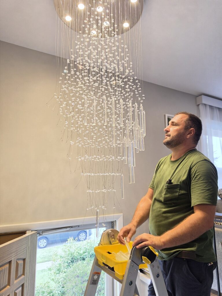 Crystal chandelier installation Chicago — inspecting a finished chandelier