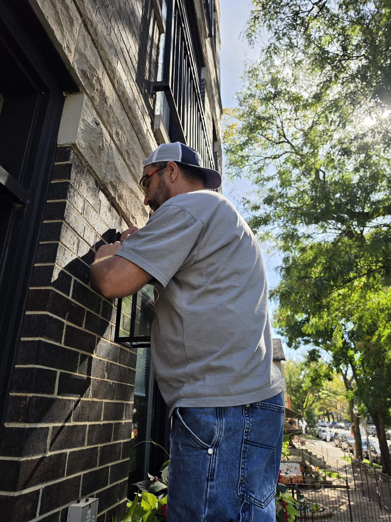 Electrical installation in Chicago — handyman installing an outdoor fixture